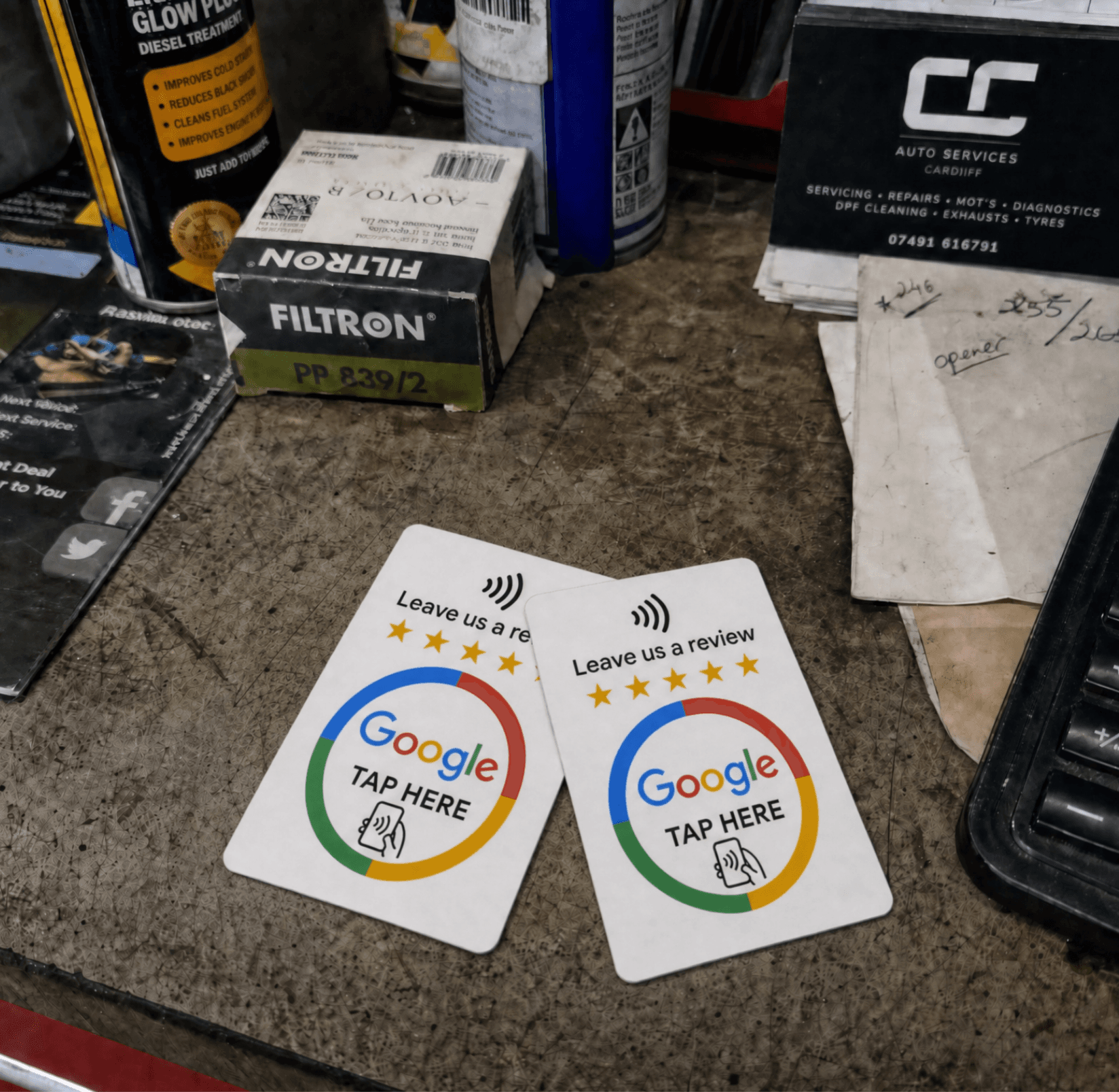 Two RevuBoost Google review cards on a business counter