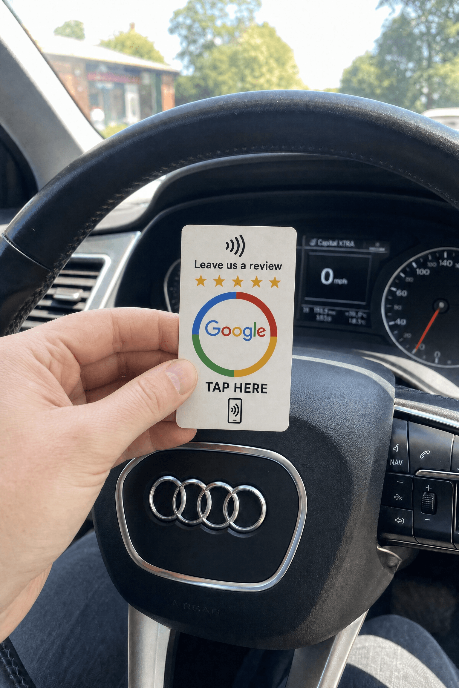 Electrician holding a RevuBoost Google review card in his van